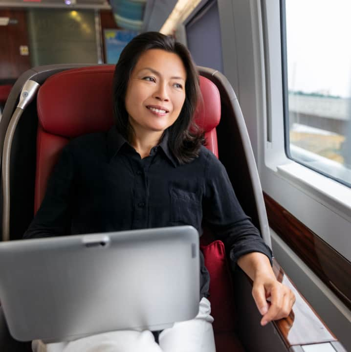 A woman on a bus with a laptop